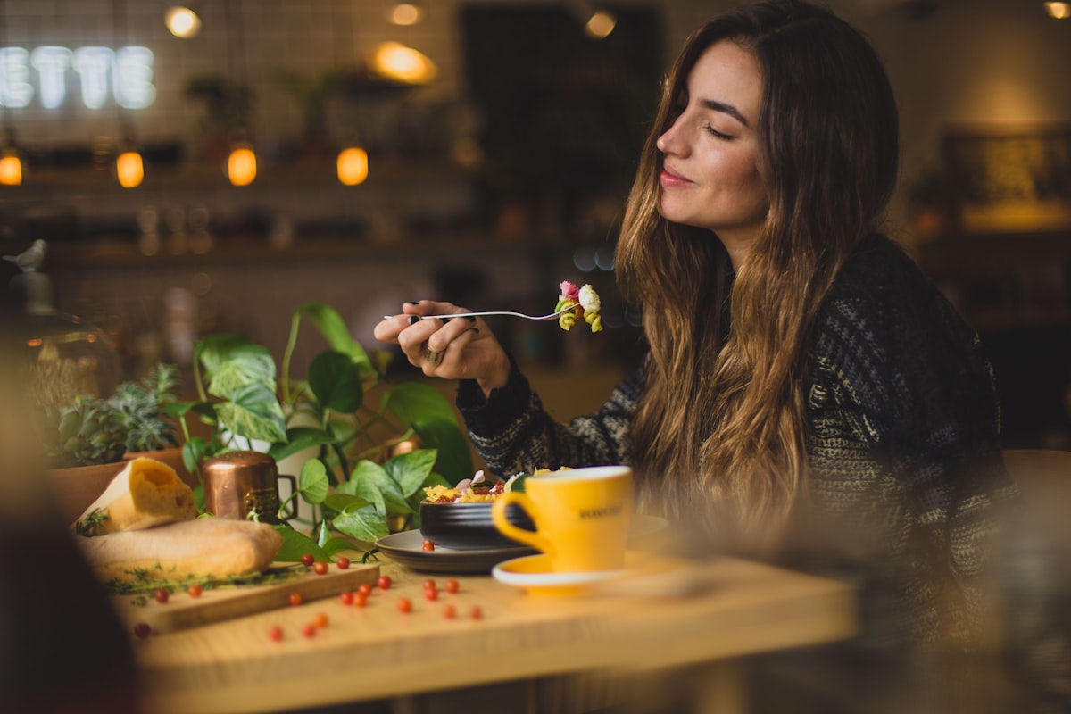 A guest enjoying dinner in a warmly lit Budapest bistro