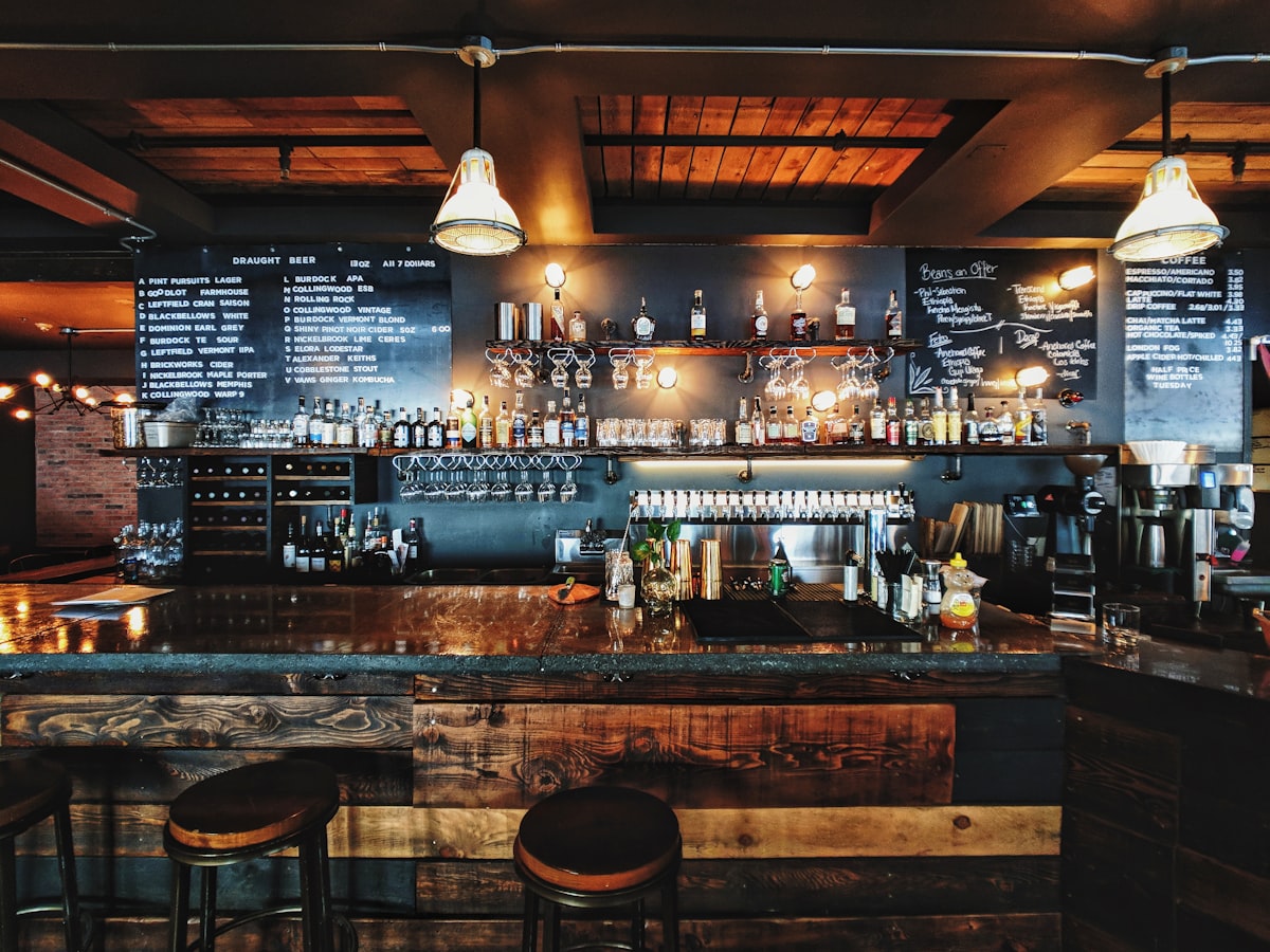 The warm, cluttered bar counter of a Budapest ruin pub at night